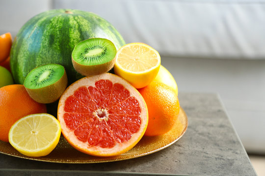 Fresh fruits on table in living room, close up