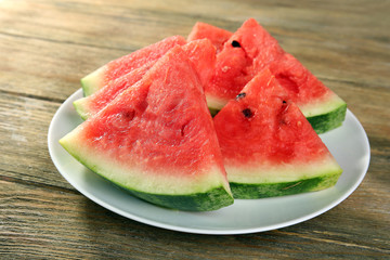 Slices of ripe watermelon on wooden table close up