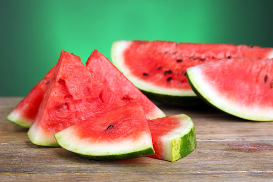 Slices of ripe watermelon on green background