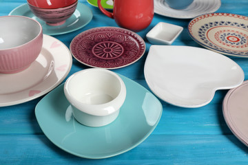 Different tableware on wooden table close up