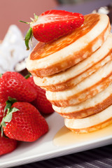 Pancakes with honey and strawberries