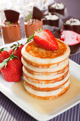 Pancakes with honey and strawberries