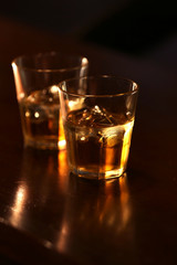 Whiskey glass tumbler standing on bar counter