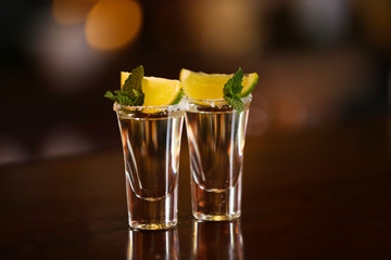 Shot glasses with tequila on bar counter