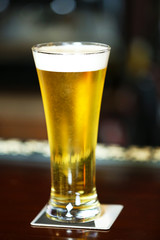 Cold beer glass on bar or pub desk