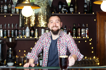 Portrait of handsome bartender at workplace
