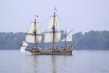 Fototapeta na wymiar The Susan Constant, Godspeed and Discovery, re-creations of the three ships that brought English colonists to Virginia in 1607, flying the English and Union Jack flags and sailing down the James River on May 12, 2007, as part of the 400th Anniversary program of the founding of Jamestown, Virginia