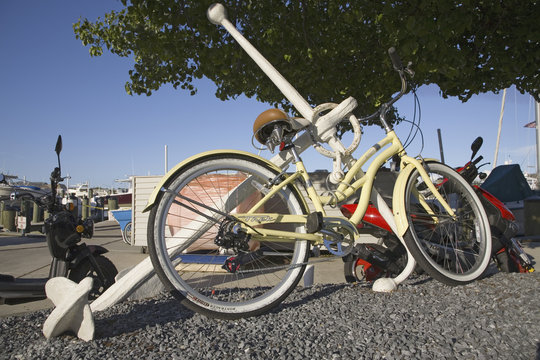 White Bicycle Parked Against Anchor At Yacht Club In Annapolis, Maryland