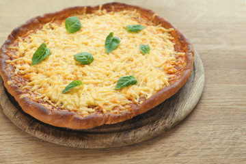 Cheese pizza with basil on table close up