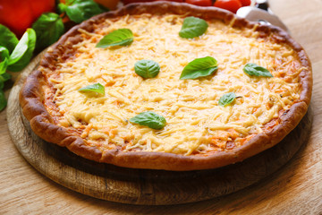 Cheese pizza with vegetables on table close up
