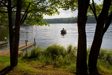 Naklejka premium Fishing boat on a wilderness lake.