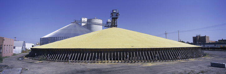 Panoramic image of a pyramid of corn stored along freight yard in North Platte, Nebraska