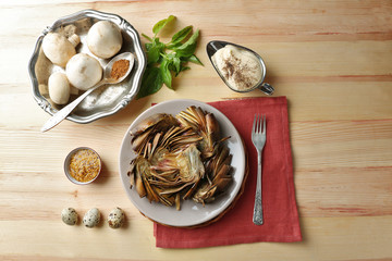 Roasted  artichokes on plate, on color wooden background
