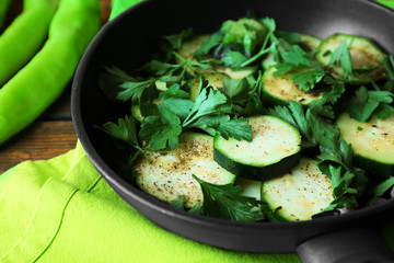Sliced zucchini in pan on table, closeup