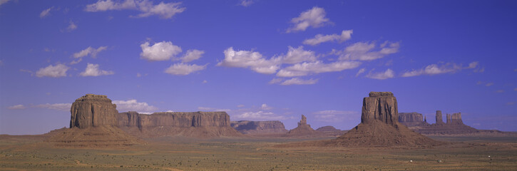 Panoramic view of red buttes and colorful spires of Monument Valley Navajo Tribal Park, Southern Utah near Arizona border