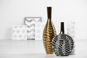 Modern vases on floor in room