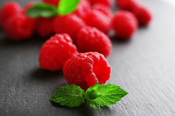 Fresh red raspberries on wooden table, closeup