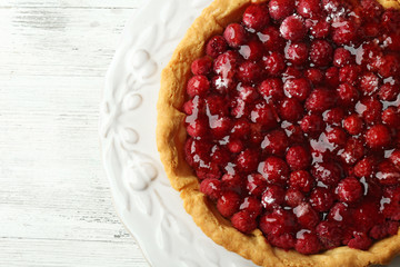 Tart with raspberries, on wooden background
