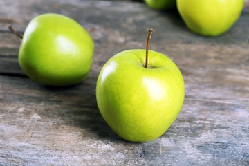 Ripe green apples on wooden table close up