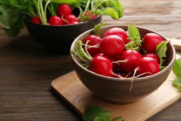 Fresh red radish on wooden table, closeup