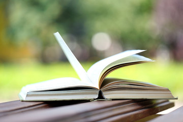 Stack of books outdoors, on blurred background