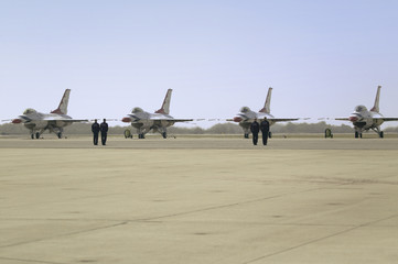 US Air Force pilots standing at attention in front of their F-16C Fighting Falcons, known as the Thunderbirds before flying at the 42nd Naval Base Ventura County (NBVC) Air Show at Point Mugu, Ventura County, Southern California.