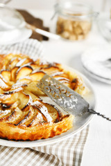 Homemade apple pie on plate, on white wooden table background background
