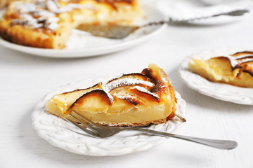 Homemade apple pie on plate, on white wooden table background background