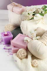 Massage bags with spa treatment and flowers on wooden table background