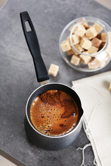 Turk of flavored coffee on table with napkin, closeup
