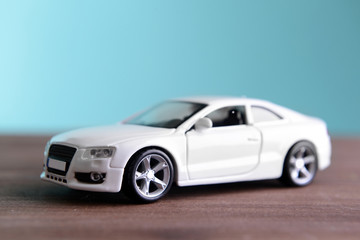 Obraz na płótnie Canvas Small toy car on blue background
