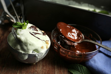 Homemade ice cream in frozen metallic container on dark wooden background