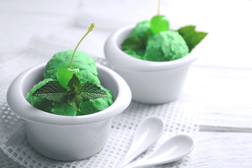 Homemade mint ice-cream on light wooden background