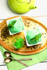 Homemade green tea ice-cream on light wooden background