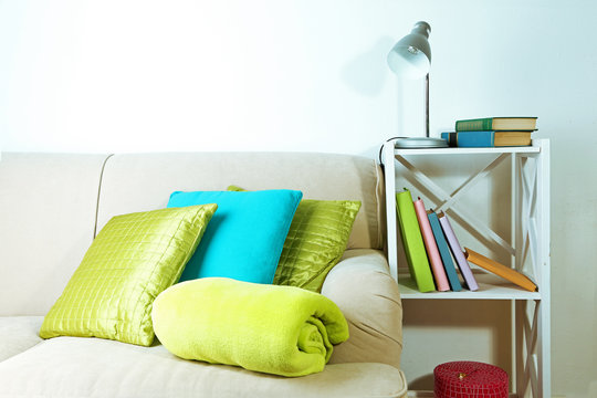 Colorful pillows on sofa, close-up, on home interior background