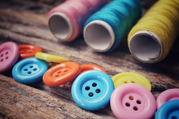 Colorful sewing buttons with thread