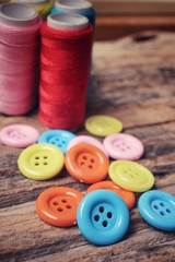 Colorful sewing buttons with thread