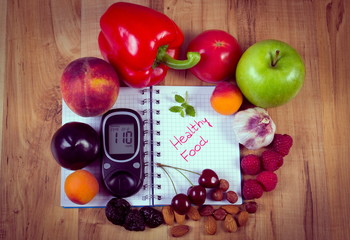 Vintage photo, Fruits and vegetables with glucometer and notebook for notes, healthy food, diabetes