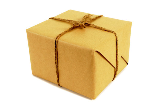 One single small square brown paper package parcel tied with string isolated on white background photo