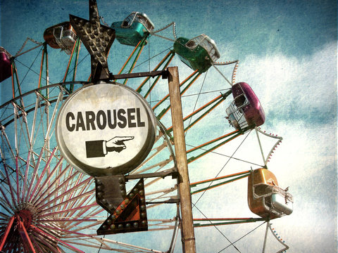 aged and worn vintage photo of carousel sign with ferris wheel