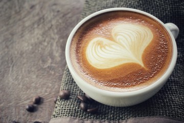 Vintage latte art coffee with beans