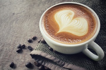 Vintage latte art coffee with beans