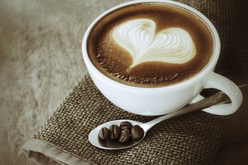 Vintage latte art coffee with beans