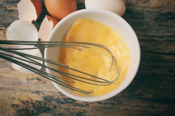 Fototapeta na wymiar Eggs in a bowl with whisk