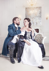Beautiful couple woman and man in medieval clothes