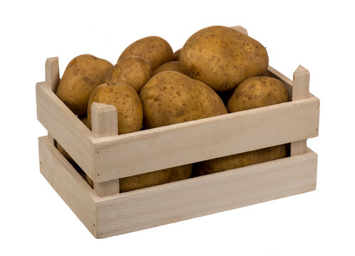 Potatoes in the wooden box isolated.