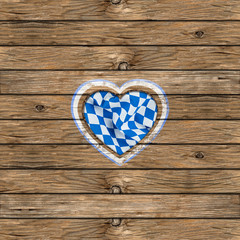 wooden oktoberfest background with heart shaped cut out  and bavarian flag