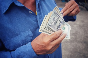 Senior man holding of dollars