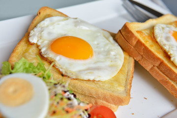 Dish croque-madame with beautiful fried eggs, bread and ham, shallow DOF in natural light closeup image