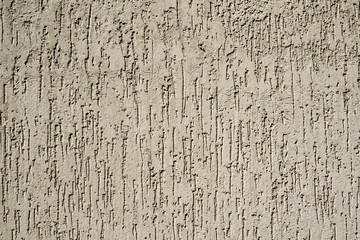 Texture of cream plaster wall in form of raindrops